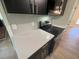 Modern kitchen featuring stainless steel appliances, sleek black cabinets, and white quartz countertops at 1116 Shadywood Ln, Raleigh, NC 27603