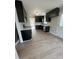 Spacious kitchen featuring black cabinets, stainless steel appliances, white countertops, and light wood floors at 1116 Shadywood Ln, Raleigh, NC 27603