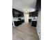 Stylish kitchen features black cabinets, stainless steel appliances, white countertops, and modern backsplash at 1116 Shadywood Ln, Raleigh, NC 27603
