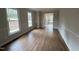Bright living room featuring hardwood floors, large windows, and decorative trim at 1116 Shadywood Ln, Raleigh, NC 27603