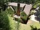 View of the exterior with a deck surrounded by lush trees and greenery at 1116 Shadywood Ln, Raleigh, NC 27603