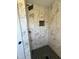 Elegant marble-style tile and a sleek glass enclosure make this shower luxurious at 1116 Shadywood Ln, Raleigh, NC 27603