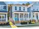 Charming two-story home featuring a welcoming front porch, complemented by a vibrant blue door and neat landscaping at 113 Weavers Grove Dr, Chapel Hill, NC 27514