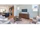 Inviting living room featuring wood floors, stylish furnishings, and an open layout connecting to the modern kitchen at 113 Weavers Grove Dr, Chapel Hill, NC 27514