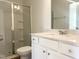 Clean bathroom with a glass-enclosed shower, quartz countertop, and vanity with storage at 114 Tee Time Ter, Benson, NC 27504