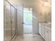 Bathroom featuring a glass shower, double vanity with stone countertops, and tile flooring at 114 Tee Time Ter, Benson, NC 27504