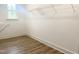 Walk-in closet features wood look floors, wire shelving, and a window for natural light at 114 Tee Time Ter, Benson, NC 27504