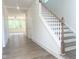 Bright entryway with hardwood floors and stairs leading to the second floor at 114 Tee Time Ter, Benson, NC 27504