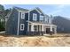 Charming new two-story home with a welcoming front porch and attached two car garage, set on a spacious lot at 114 Tee Time Ter, Benson, NC 27504