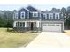 Beautiful two-story home featuring stone accents, a two-car garage, and manicured lawn at 114 Tee Time Ter, Benson, NC 27504