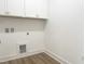 A utility room features sleek cabinets, vinyl floors, and appliance hookups at 114 Tee Time Ter, Benson, NC 27504