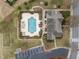Overhead shot of community pool, clubhouse, parking, and surrounding landscaping at 1146 Blue Bird Ln, Wake Forest, NC 27587
