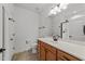 Bathroom with wood cabinets, vanity sink, a large mirror, and modern fixtures throughout at 1146 Blue Bird Ln, Wake Forest, NC 27587