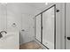 Well-lit bathroom featuring a walk-in shower with glass doors, white subway tile, and modern fixtures at 1146 Blue Bird Ln, Wake Forest, NC 27587
