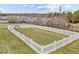 Community dog park surrounded by white picket fence and black metal fencing at 1146 Blue Bird Ln, Wake Forest, NC 27587