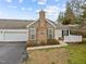 View of home showcasing the attached garage and well-maintained landscaping at 1146 Blue Bird Ln, Wake Forest, NC 27587