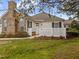 Charming home featuring a brick chimney and inviting white picket fence enhancing its curb appeal at 1146 Blue Bird Ln, Wake Forest, NC 27587