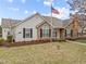 Charming single-story home featuring a well-manicured lawn and classic American flag at 1146 Blue Bird Ln, Wake Forest, NC 27587