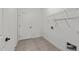 Well-lit laundry room features tiled floor, wire rack shelving, and utility connections at 1146 Blue Bird Ln, Wake Forest, NC 27587