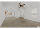 Open concept living room with ceiling fan, lots of light, and view of the kitchen at 1146 Blue Bird Ln, Wake Forest, NC 27587