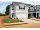 Two-story townhome showcasing its gray siding and 2-car garage, with minimal landscaping and signage in place at 1165 Abbott St, Mebane, NC 27302