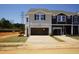 Charming new construction townhomes featuring attached garages and craftsman-style design with black and gray accents at 1165 Abbott St, Mebane, NC 27302