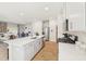 Open-concept kitchen with a large island, stainless steel appliances, and hardwood floors at 1165 Abbott St, Mebane, NC 27302
