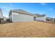 Spacious backyard with black metal fence and view of neighboring homes in a well-maintained community at 1206 Linkwood Way, Fuquay Varina, NC 27526