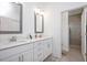 Bright bathroom boasts double sinks, white cabinets, gray framed mirrors and a tiled walk-in shower at 1206 Linkwood Way, Fuquay Varina, NC 27526