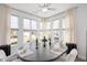 Dining area with large windows, neutral curtains, and round table with seating for six at 1206 Linkwood Way, Fuquay Varina, NC 27526