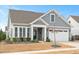 Beautiful home boasts a two-car garage, inviting front porch, and charming curb appeal at 1206 Linkwood Way, Fuquay Varina, NC 27526
