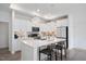 Modern kitchen with white cabinetry, stainless steel appliances, and a sleek center island with seating at 1206 Linkwood Way, Fuquay Varina, NC 27526
