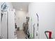 Functional laundry room with storage shelves, cleaning supplies, and modern washer/dryer units at 1206 Linkwood Way, Fuquay Varina, NC 27526