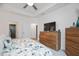 Well-lit main bedroom with a tray ceiling, wooden dressers, and comfortable king bed at 1206 Linkwood Way, Fuquay Varina, NC 27526