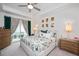 Serene main bedroom with a tray ceiling, bedside tables, and access to a private balcony at 1206 Linkwood Way, Fuquay Varina, NC 27526