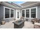 Back patio with multiple chairs, windows, door, and a fire pit at 1206 Linkwood Way, Fuquay Varina, NC 27526