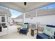 Relaxing screened porch featuring comfortable blue chairs and elegant decor at 1206 Linkwood Way, Fuquay Varina, NC 27526