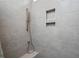 A tiled shower featuring a handheld shower head and built-in shower niche at 1206 Linkwood Way, Fuquay Varina, NC 27526