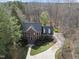 Aerial view of brick home with dormer windows and mature landscaping at 12101 Lockhart Ln, Raleigh, NC 27614