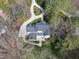Aerial view of a grey roofed home with a large stone patio, lawn and landscaping at 12101 Lockhart Ln, Raleigh, NC 27614