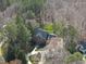 Aerial view highlighting the property's landscaping, circular driveway, and proximity to surrounding trees at 12101 Lockhart Ln, Raleigh, NC 27614