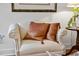 Comfortable white armchair with copper pillows and decorative nailhead trim near a side table with lamp at 12101 Lockhart Ln, Raleigh, NC 27614