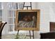 Gold framed apple painting on easel in naturally lit room at 12101 Lockhart Ln, Raleigh, NC 27614