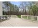 Back deck featuring an outdoor dining area and railings with a view of the expansive backyard at 12101 Lockhart Ln, Raleigh, NC 27614