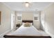 Bright bedroom with natural light, neutral decor, and ceiling fan at 12101 Lockhart Ln, Raleigh, NC 27614