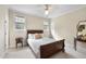 Cozy bedroom featuring a ceiling fan, windows that provide natural light, and neutral decor at 12101 Lockhart Ln, Raleigh, NC 27614
