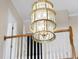Close-up of a tiered, glass chandelier fixture hanging over a staircase at 12101 Lockhart Ln, Raleigh, NC 27614