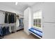 Bright walk-in closet featuring custom shelving, ample storage, window seat and natural light at 12101 Lockhart Ln, Raleigh, NC 27614