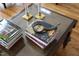 Close-up of a glass top coffee table featuring decorative books and accessories adding character to the living space at 12101 Lockhart Ln, Raleigh, NC 27614