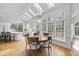 Bright dining area with hardwood floors, skylights, an adjacent kitchen, and large windows at 12101 Lockhart Ln, Raleigh, NC 27614